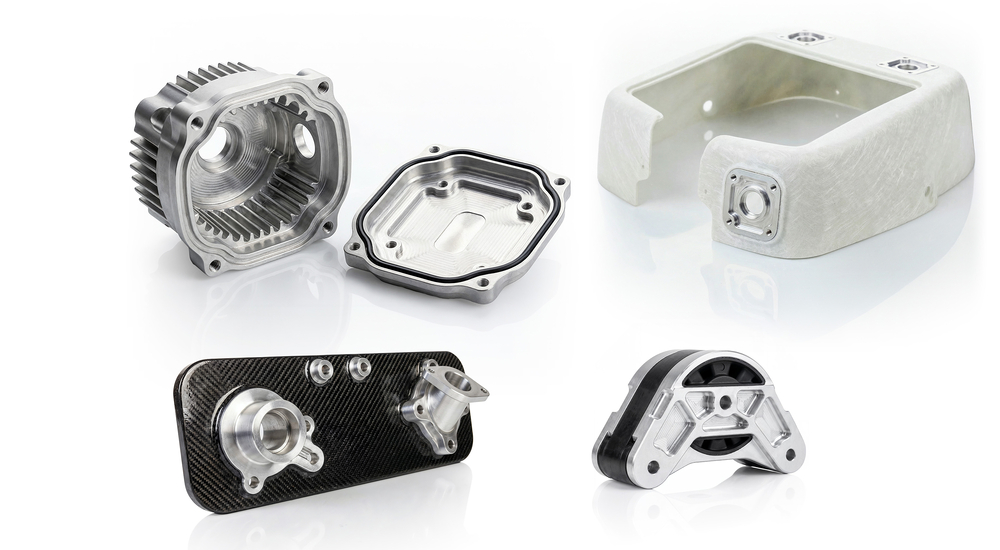 Das Bild zeigt verschiedene technische Bauteile, wahrscheinlich aus dem Maschinenbau oder der Automobiltechnik, aus unterschiedlichen Materialien wie Aluminium und Carbon.